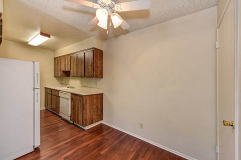 Dining Room with Hardwood Inspired Floor, Refrigerator, Ceiling Fan/Light and Wood Cabinets